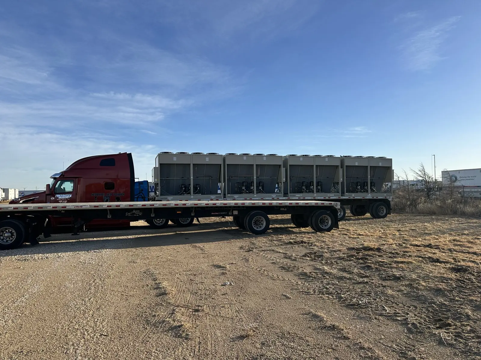 Flatbed truck loaded with air-cooled chillers ready for delivery to site